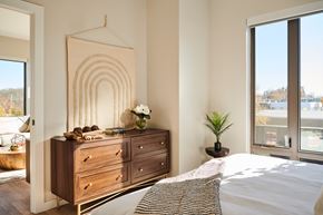 Burlington apartment for rent - a bedroom with a bed and a dresser and a window