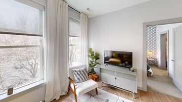 Providence apartment for rent - A living room with a television and a chair.