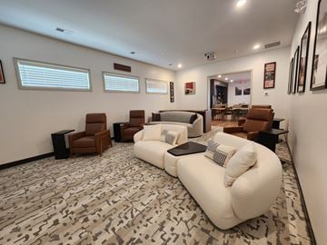 Coraopolis apartment for rent - A living room with a white couch and brown chairs.