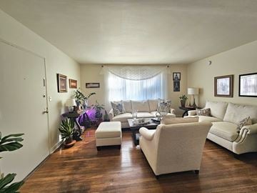 Reading apartment for rent - A living room with a white couch and a white chair.