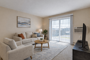 Reading apartment for rent - A living room with a grey couch, a wooden coffee table, and a painting on the wall.