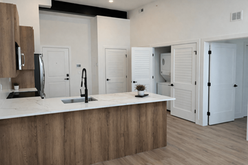 Philadelphia apartment for rent - A modern kitchen with a wooden counter and white cabinets.