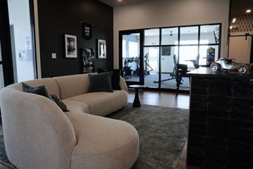 Dover apartment for rent - A living room with a grey couch and a black wall.