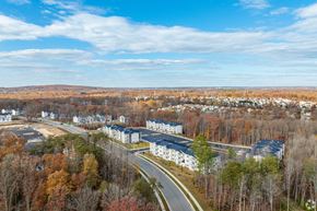 Newark apartment for rent - A road goes through a residential area with trees on both sides.