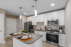 Newark apartment for rent - A modern kitchen with a granite countertop and stainless steel appliances.
