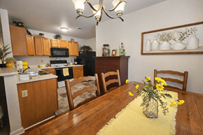 Sinking Spring apartment for rent - A kitchen with wooden floors and a yellow rug in the middle.
