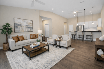 Cranberry Township apartment for rent - A living room with a white couch, a coffee table, and a painting on the wall.
