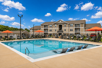 East Pennsboro apartment for rent - A large swimming pool in front of a multi-story apartment building.