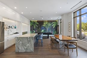 Germantown apartment for rent - A kitchen with a marble island and a dining table with chairs.