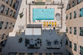 Germantown apartment for rent - A swimming pool surrounded by yellow chairs and umbrellas.