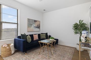 Germantown apartment for rent - A living room with a blue couch and a painting on the wall.