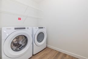 Spanaway apartment for rent - Two white Whirlpool washing machines in a laundry room.