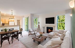 Bothell apartment for rent - A living room with a fireplace and a flat screen TV mounted on the wall.