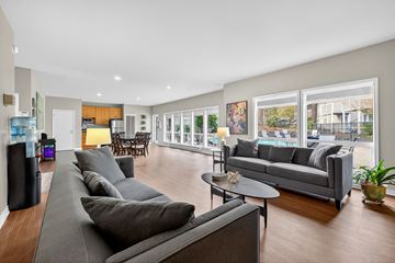 Bellevue apartment for rent - A living room with a grey couch and a black speaker.