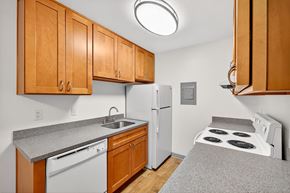 Bellevue apartment for rent - A kitchen with a stove top oven and a refrigerator.