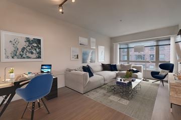 Seattle apartment for rent - A modern living room with a blue chair and a white couch.
