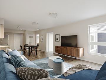 Seatac apartment for rent - A modern living room with a blue sofa and a television.
