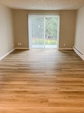 Federal Way apartment for rent - A room with wooden flooring and a sliding glass door.