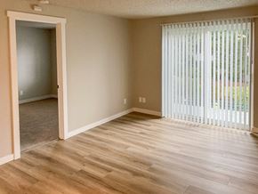 Federal Way apartment for rent - A room with a wooden floor and a sliding glass door.