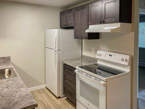 Federal Way apartment for rent - A kitchen with a white fridge and stove.