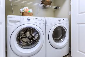 Dupont apartment for rent - Two white Whirlpool washing machines in a laundry room.