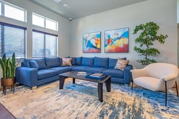 Spanaway apartment for rent - A living room with a blue couch and a white chair.