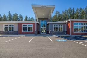 Spanaway apartment for rent - A parking lot with a building that has the number 19422 on it.