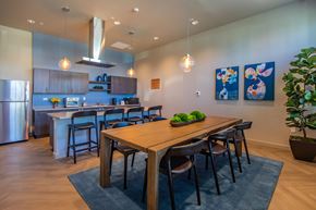 Spanaway apartment for rent - A modern kitchen with a dining table and chairs.