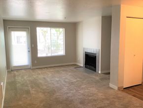 Seattle apartment for rent - A living room with a fireplace and a carpeted floor.