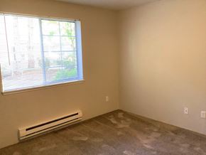 Seattle apartment for rent - A room with a window and a wall-mounted air conditioner.