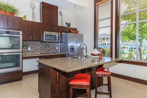Dupont apartment for rent - A kitchen with a brown counter top and red bar stools.
