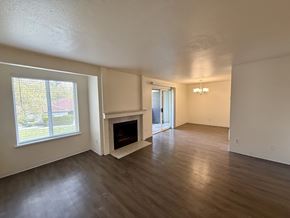 Gig Harbor apartment for rent - A living room with a fireplace and a sliding glass door.