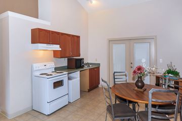 Federal Way apartment for rent - A kitchen with a white stove and brown cabinets.
