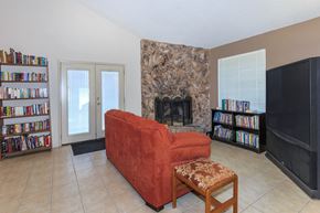 Federal Way apartment for rent - A living room with a red couch, a fireplace, and a bookshelf.