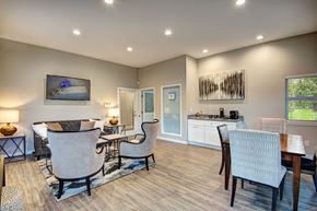Kent apartment for rent - A well-lit living room with a dining area and a kitchen in the background.