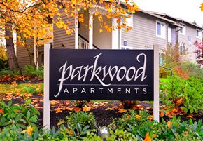 Kent apartment for rent - A sign for Parkwood Apartments is in front of a building.