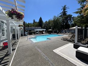 Gig Harbor apartment for rent - A pool area with a white fence and a red chair.