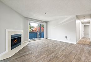 Kent apartment for rent - A modern living room with a fireplace and sliding glass doors.