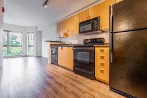 Seattle apartment for rent - A kitchen with wooden cabinets and stainless steel appliances.