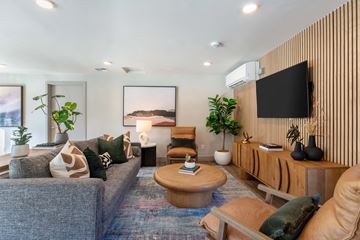 Kent apartment for rent - A living room with a grey couch, a wooden coffee table, and a large painting on the wall.