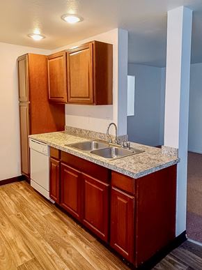 Kent apartment for rent - A kitchen with wooden cabinets and a white dishwasher.