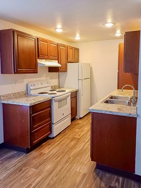 Kent apartment for rent - A kitchen with wooden cabinets and a white refrigerator.