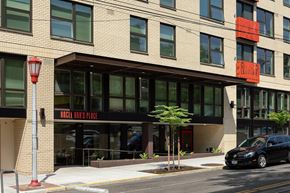 Seattle apartment for rent - A building with a black car parked in front of it.
