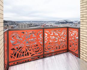 Seattle apartment for rent - A balcony with a red railing and a view of a cityscape.