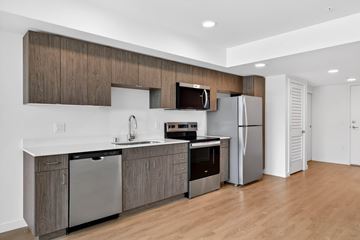 Seattle apartment for rent - A modern kitchen with wooden cabinets and stainless steel appliances.