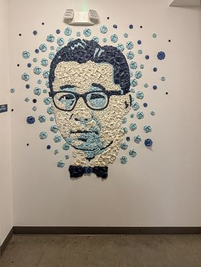 Seattle apartment for rent - A portrait made of blue and black objects is on a white wall.