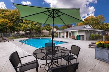Auburn apartment for rent - A patio with a table and chairs and a pool.