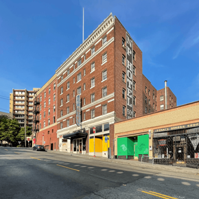 Seattle apartment for rent - A large red brick building with the words "NY PYTHON HOTEL" on the side.