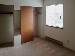 Kent apartment for rent - A room with a brown door and a window with blinds.