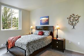 Redmond apartment for rent - A bedroom with a large bed and a painting on the wall.